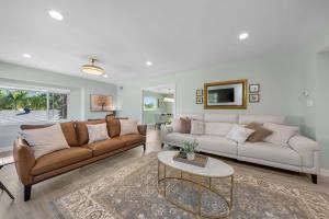 a living room with two couches and a table at Family Hilltop luxe retreat with breathtaking views in La Mesa