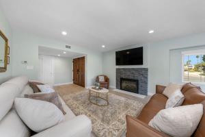 a living room with a couch and a fireplace at Family Hilltop luxe retreat with breathtaking views in La Mesa