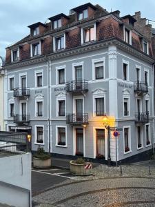 a large white building with a lot of windows at Hotel Bischoff in Baden-Baden