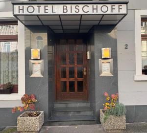 a hotel storefront with a door and a sign above it at Hotel Bischoff in Baden-Baden