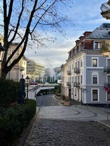 a cobblestone street in a city with buildings at Hotel Bischoff in Baden-Baden