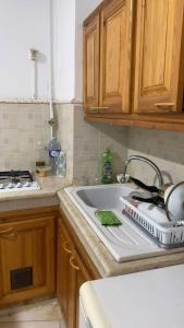 a kitchen counter with a sink and a stove at Charmant studio au cœur dAlger in Alger