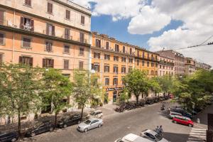 a city street with cars parked in front of buildings at New albatros in Rome