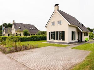 a house with a brick driveway in front of it at Detached house in Vlagtwedde with sauna in Vlagtwedde