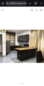 a living room with a table and a kitchen at Emerald harbor apartments in Lekki