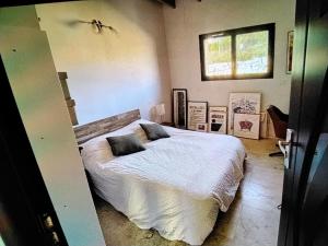 a bedroom with a bed with two pillows on it at Viviloue in Saint-Pierre-Lafeuille
