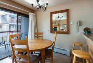 a dining room with a table and chairs and a mirror at River Mountain Lodge Peaks Trail Condo: Ski-In, Downtown Breck in Breckenridge