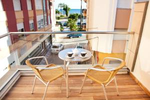a balcony with a table and chairs and a view of the ocean at Apartamentos Poniente - Mares in Torre del Mar