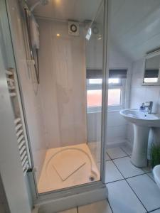 a bathroom with a shower and a sink at 2 bed central apartments in South Shields