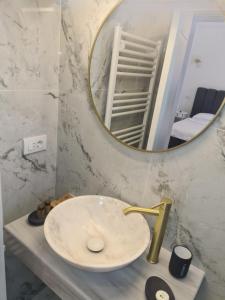 a bathroom sink with a large mirror above it at Jolie Hotel in Craiova +34 photos