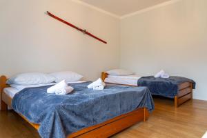 two beds in a room with blue sheets at Ski Lodge przy Gondoli - Szczyrk in Szczyrk