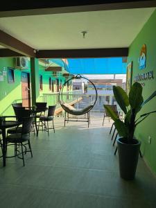 eine Terrasse mit Stühlen und einer Schaukel in einem Gebäude in der Unterkunft Pousada Paraíso Tropical in Penha + 98 Fotos
