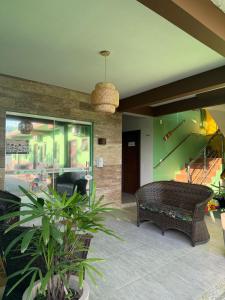 a living room with a couch and a piano at Pousada Paraíso Tropical in Penha +80 photos