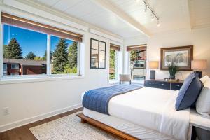 a bedroom with a large bed and a window at Atelier Alpine - Modern 2BD Condo w/Baldy Views in Sun Valley