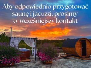 an outdoor wedding with a barrel and a sunset at Gackowo in Ostróda