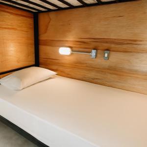 a pair of beds in a room with wooden walls at O Ogro in Brasilia