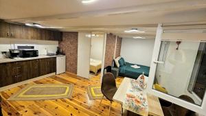 a room with a kitchen and a living room at Căsuța din poveste in Sohodol