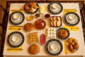 a table topped with plates of pastries and biscuits at Zghapari Wooden Mountain Lodge in Aspindza
