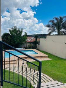 a view of a swimming pool from the balcony of a house at Suider home stay in Johannesburg