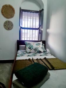 Ένα ή περισσότερα κρεβάτια σε δωμάτιο στο Amore Stone Town Zanzibar Apartment by Monalisa