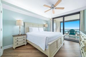 a bedroom with a bed and a ceiling fan at Summer House Unit 602A in Orange Beach