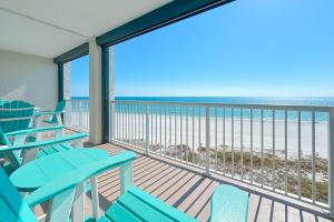 a balcony with chairs and a view of the ocean at Summer House Unit 602A in Orange Beach