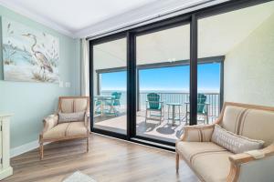 a living room with a view of the ocean at Summer House Unit 602A in Orange Beach