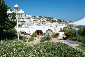 a white building with flowers in front of it at Hotel Ristorante Panoramico in Castro di Lecce