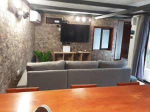 a living room with a couch and a television at RUBYAi in Icod el Alto