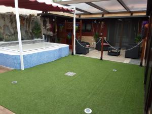 a putting green with a hot tub in a house at RUBYAi in Icod el Alto