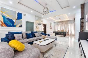 a living room with a couch and a table at 3 bedroom Masionette in Lekki