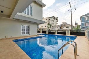 a swimming pool in front of a house at 3 bedroom Masionette in Lekki