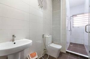 a white bathroom with a sink and a toilet at 3 bedroom Masionette in Lekki +12 photos