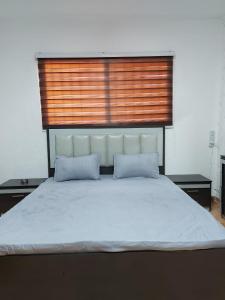 a large bed with two pillows in a bedroom at Stone house in Amman +6 photos