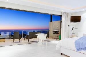 a bedroom with a view of the ocean at Sea Mount in Cape Town