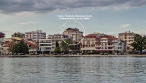 a group of buildings next to a body of water at Top Spot Studio in Ohrid