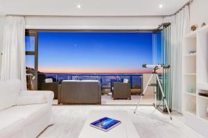 a living room filled with furniture and a tv at Sea Mount in Cape Town
