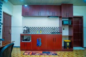 a toy kitchen with wooden cabinets in a room at Spacious 4-Bedroom Apartment for families & groups in Benin City +3 photos