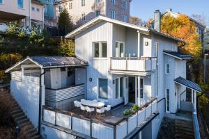 eine Luftansicht eines Hauses mit einer Terrasse in der Unterkunft Villa Rajaportti Loft with lake view and free front door parking&electric car plugs in Tampere