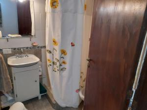 une salle de bain avec un rideau de douche et un lavabo dans l'établissement Tu Alojamiento en Mar del Plata, à Mar del Plata