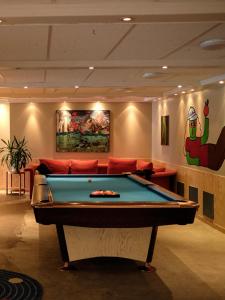 a room with a pool table and a couch at Balestrand Hotel in Balestrand