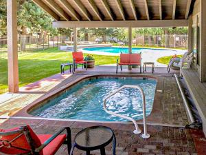 a swimming pool with chairs and an umbrella at Sun Valley Condo 123 in Ketchum