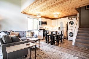 a living room with a couch and a kitchen at Modern Golf View Condo + Resort Amenities in Sun Valley