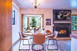 a dining room with a table and chairs and a fireplace at Sun Valley Condo 123 in Ketchum