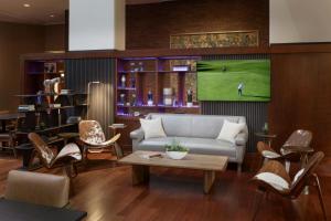 a living room with a couch and a table and chairs at Kansas City Marriott Downtown in Kansas City
