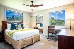 a bedroom with a bed and a desk and two windows at Modern Golf View Condo + Resort Amenities in Sun Valley +19 photos