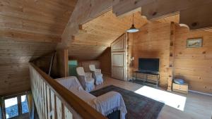 a living room with wood paneling and a television at Mountain Chalet in Beauvezer in Beauvezer