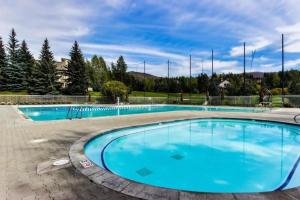 a large swimming pool with blue water at Modern Golf View Condo + Resort Amenities in Sun Valley