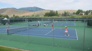 a group of children playing tennis on a tennis court at Modern Golf View Condo + Resort Amenities in Sun Valley