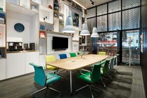 a conference room with a wooden table and chairs at citizenM Seattle South Lake in Seattle +31 photos